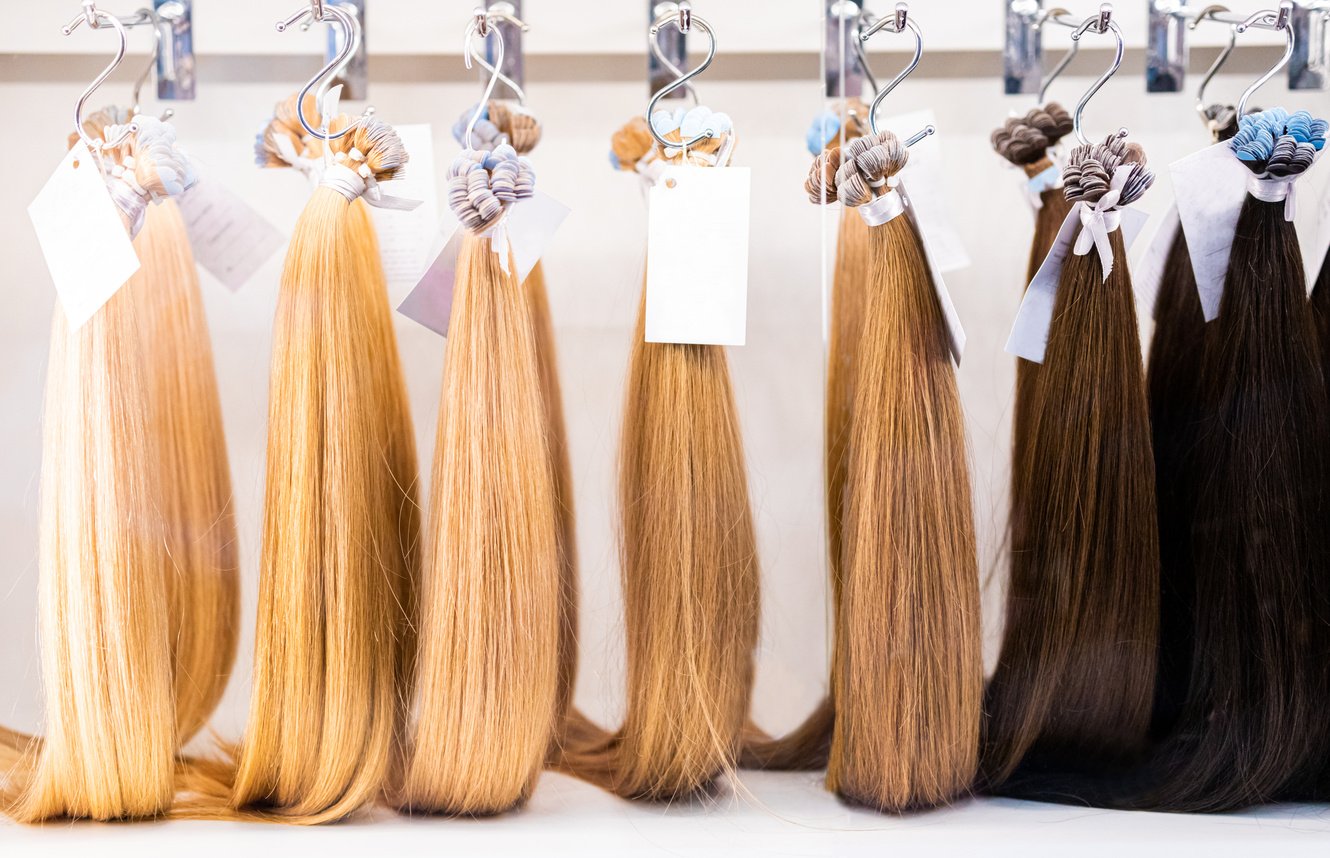 Exhibition of multicolored hair extensions in beauty salon